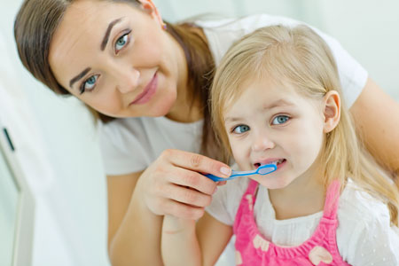 Mom and Daughter brushing their teeth - Pediatric Dentist in Duncan, SC and Spartanburg County